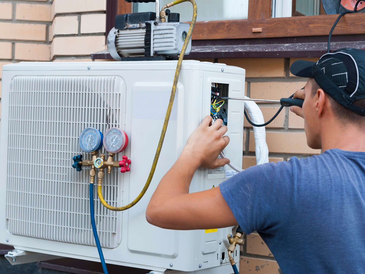 man installing cooling and heating system